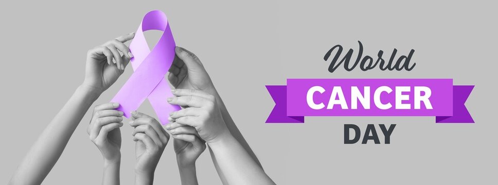 Hands holding purple awareness ribbon on grey background. World Cancer Day