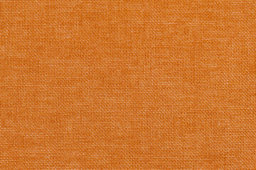 Fototapeta premium Abstract orange linen fabric background with visible natural fibers and subtle texture. Suitable for design overlays, social media graphics, and editorial use.