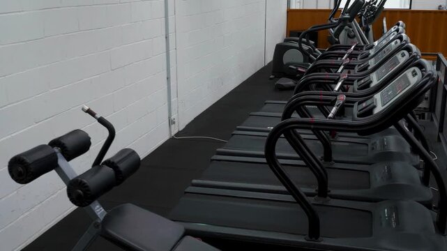 Wide view of a modern gym with treadmills.