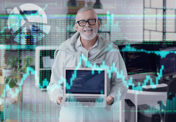 Mature programmer with laptop in office