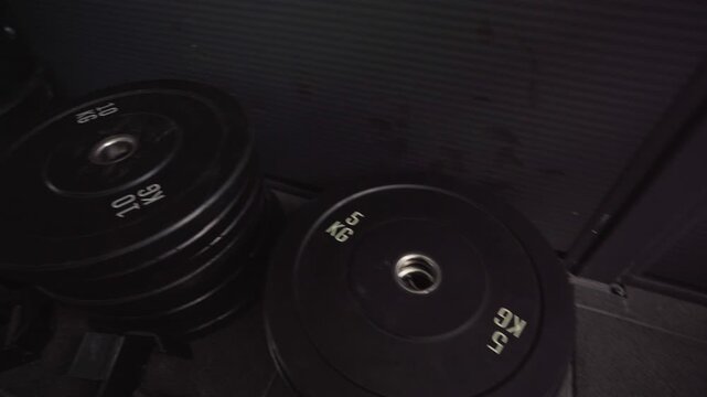 Stack of black weight plates for barbells.