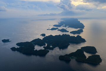 Rugged rock islands, composed of ancient, uplifted reefs, rise from the seascape in Misool, Indonesia. This region harbors spectacular marine biological diversity and is a popular destination for dive