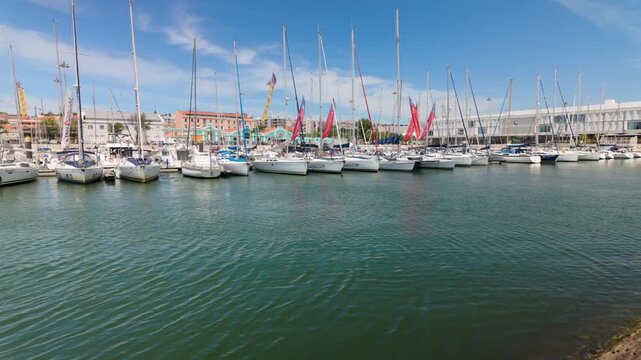 cinematic shot of marina with boats and calm water on a sunny day in Portugal.