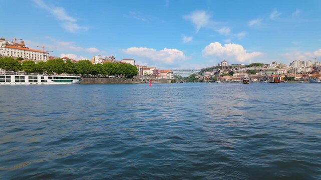 Wide shot of Douro river with city in background.