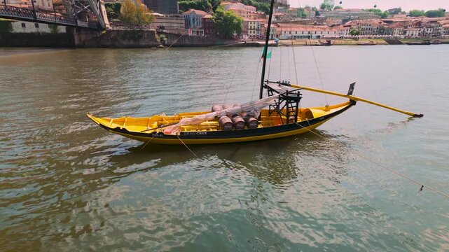 Traditional rabelo boat floating on Douro river in Porto.