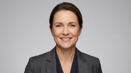 Smiling businesswoman in a formal business suit, conveys confidence and approachability