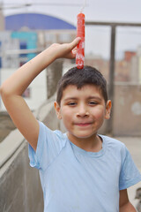 Happy latin boy holding fruit ice.