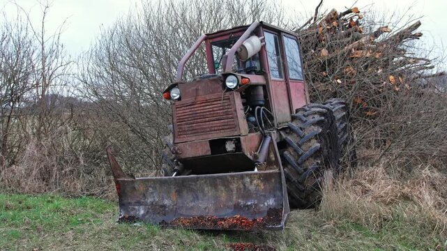 Old Heavy Duty Forestry Landscaping Bulldozer Tractor with Rusted Chassis and Mud Tread Tires