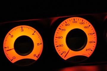 illuminated speedometer on black background