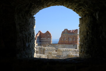 view through the castle window on the ruins of the castle tower