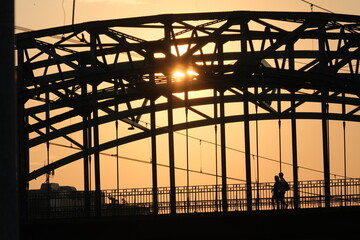 a couple on the bridge during sunset