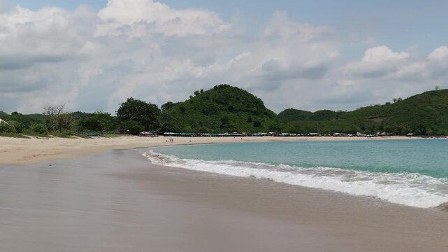 Lombok Indonesia 22 11 2025. Panoramic video of lush green vegetation, blue sea, and white sand beach forming a tropical paradise