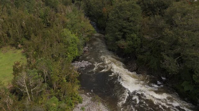 Aerial Descent Towards Turbulent Muddy River in Nature