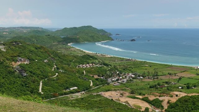 Lombok Indonesia 22 11 2025. Panoramic video of lush green vegetation, blue sea, and white sand beach forming a tropical paradise