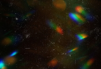 Abstract cosmic night sky with a deep dark backdrop, distant stars, and vibrant prismatic rainbow reflections across the void, creating an artistic space photography © DesignSells