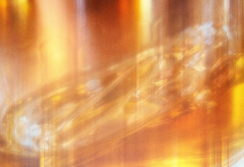 Abstract warm amber and golden orange reflective texture with light streaks and luminous surface patterns, an organic swirl suitable for luxury branding and ambient design