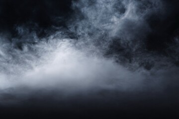 A mysterious dark cloud with billowing smoke against a dark background.