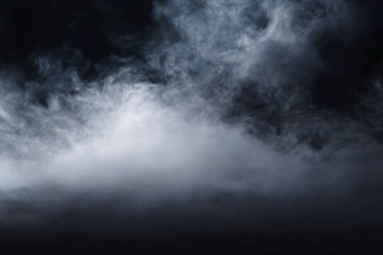 A mysterious dark cloud with billowing smoke against a dark background.