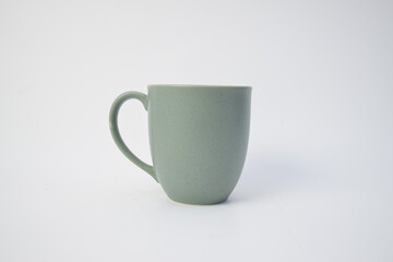 Simple sage green ceramic mug with handle isolated on white background