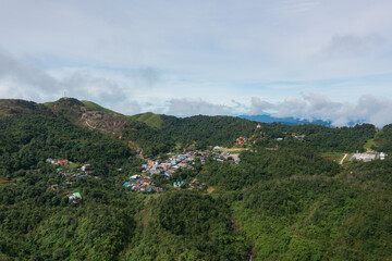 Obraz premium E-Tong Village (or Baan E-Tong) in Kanchanaburi is a charming, misty village near the Thai-Myanmar border. Aerial view from a drone.