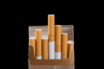 Close up of open pack of cigarettes on black background