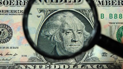 A detailed closeup shot of a magnifying glass meticulously examining the intricate details of a United States onedollar bill highlighting financial scrutiny economic analysis and the concept of monet. - Powered by Adobe