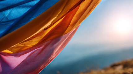 Colors of fabric flowing in the wind against a bright background, creating a serene and vibrant atmosphere.