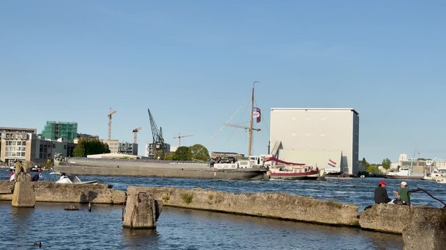 Large Cargo Ship Navigating the IJ River in Amsterdam During SAIL 2025