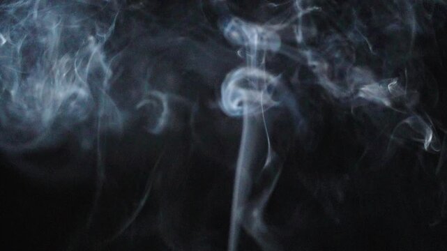 blue smoke rising isolated on black background