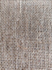Light brown burlap fabric surface.