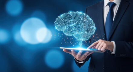 A businessman in a suit uses a tablet displaying a digital brain illustration with a blue toned bokeh background highlighting artificial intelligence.
