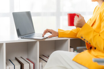 Productivity Pause: A professional, engaged in work on a laptop, finds a moment of respite to enjoy...