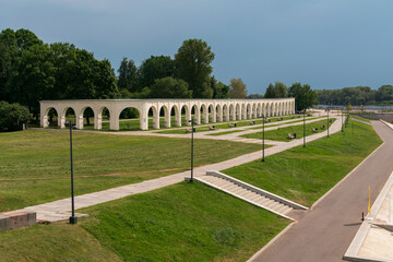 The arcade of the Gostiny Dvor on Yaroslavovo Dvorishche and the Volkhov River embankment on a sunny summer day, Veliky Novgorod, Russia