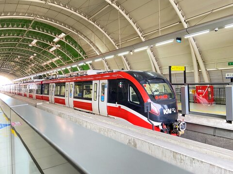 BEKASI, INDONESIA - OCTOBER 12, 2025: The red-and-white Jabodebek LRT train is captured at the platform of Jati Mulya Station. 