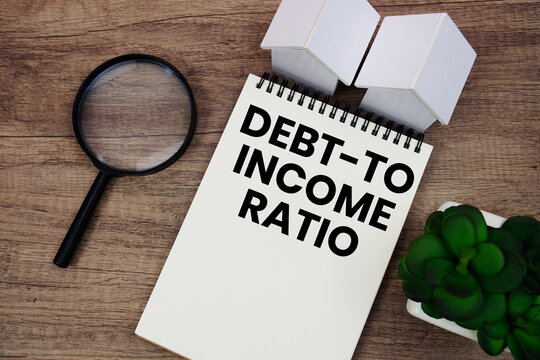 DTI Debt-to-income Ratio text written notepad with house model and magnifying glass on wooden background