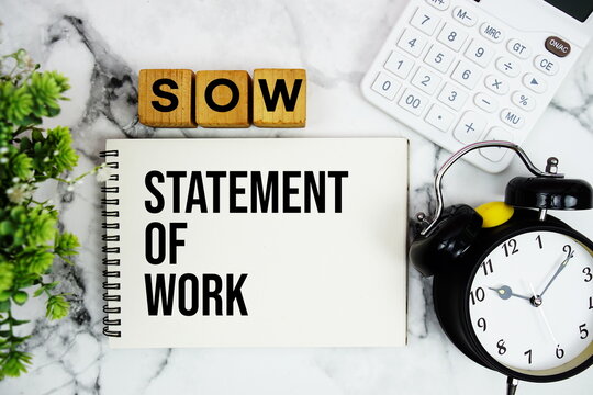 SOW Statement of Work text with calculator and alarm clock on marble background