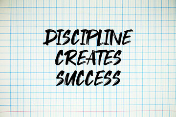 Discipline Creates Success text written on white notebook sheet with grid