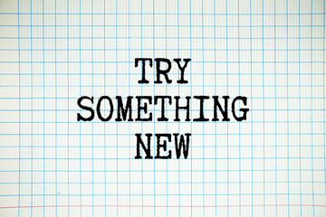 Try Something New text written on white notebook sheet with grid