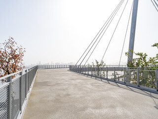 Paved waterfront with distant city skyline