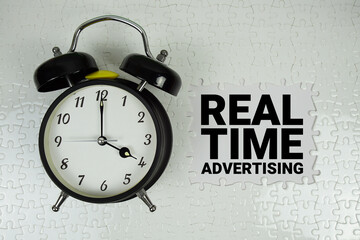 Real Time Advertising text with alarm clock on white background
