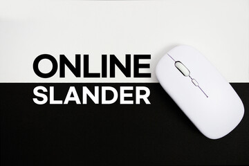 Online Slander text and wireless mouse on white and black background