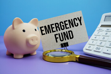 Emergency Fund text with piggy bank, calculator and magnifying glass on blue and purple background