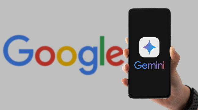 Hand holding smartphone with Google Gemini app on screen