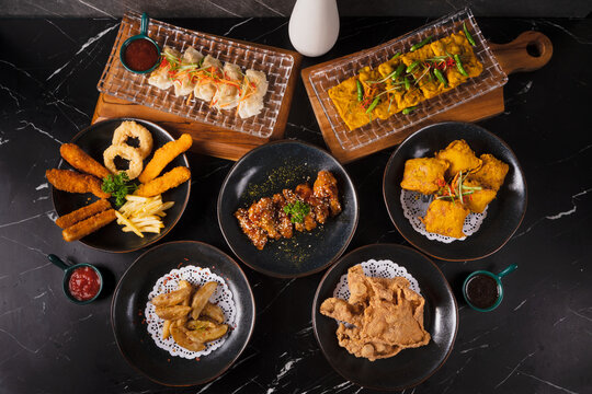 Assorted Asian Dishes on Black Table.