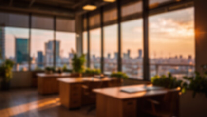 Fototapeta premium Blurred modern office interior with warm sunset light and cityscape views.