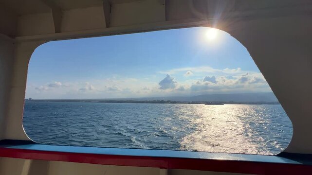 Bali, Indonesia - August 27, 2025: Car and passenger ferries cross the Bali Strait from Gilimanuk Harbor to Ketapang Harbor. View of the strait from the ferry deck. 4К