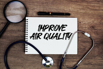 Improve Air Quality text written on notepad with stethoscope and magnifying glass on wooden background