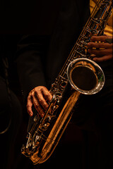 Old saxophone player hands in live performance