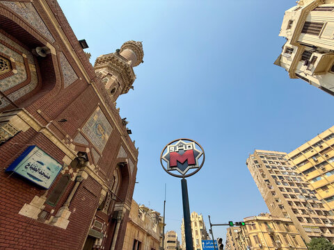 Cairo, Egypt - September 28, 2025: Low angle view of Cairo Metro sign and mosque minaret