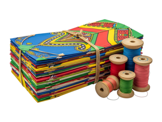 Colorful Stack of Traditional Paper Kites with Spools of Thread